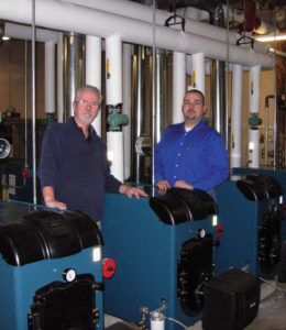 Glenn Stanton, manager of training and technical development for US Boiler (left) and Matt Plante, equipment specialist for Petro, stand in the finished mechanical room.